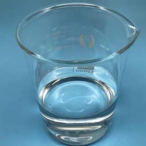 Clear glass beaker partially filled with water on a blue surface.