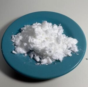 White powdery substance piled on a blue plate, viewed from above.