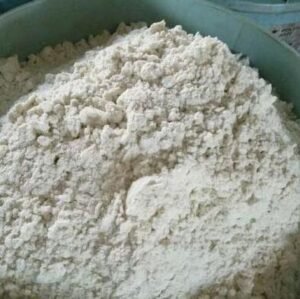 Lithium hexafluorophosphate Pile of white flour in a green mixing bowl, ready for baking.
